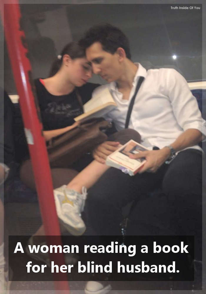 A woman reading a book for her blind husband