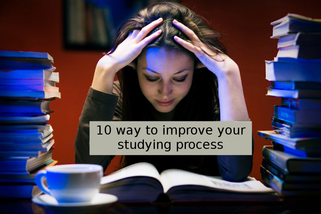 Student in a library surrounded by piles of books