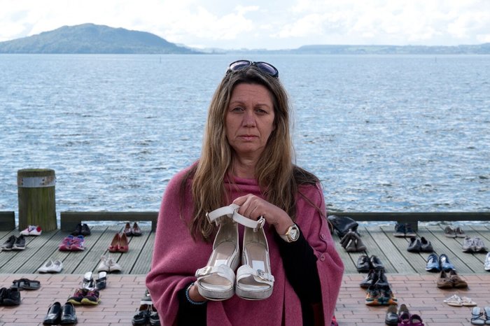 Parents hold their childrens shoes