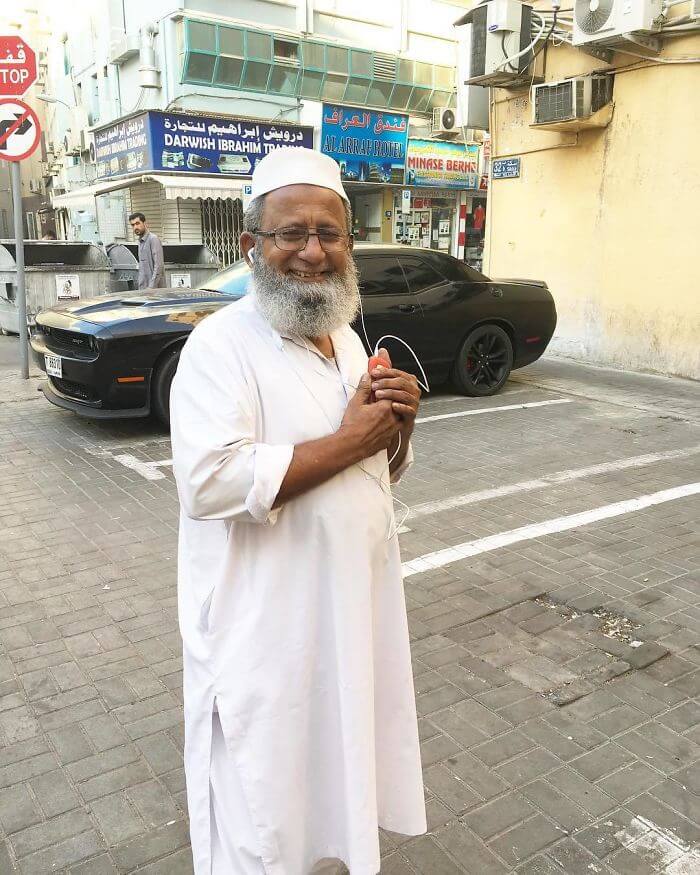I Saw This Beautiful Man Holding A Phone With Both Hands Looking At The Screen, Smiling.