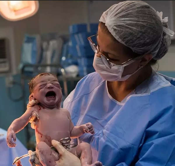 Photographer Captures Moment Newborn Baby Frowns At Doctor 3